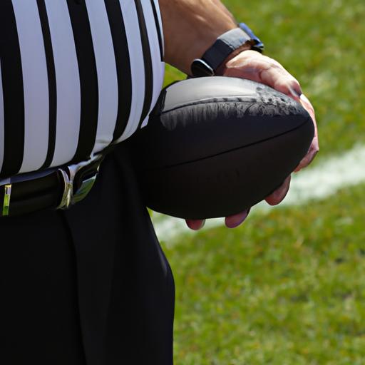 The referee prepares to make a crucial call during an NFL game.
